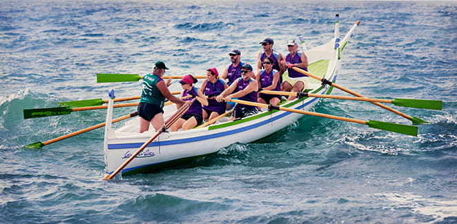 Six people rowing a boat