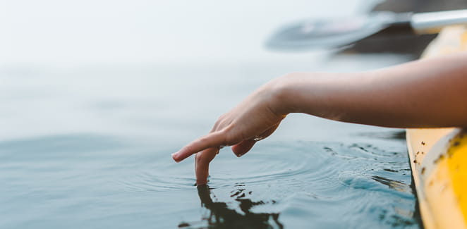Kayaker hand in water