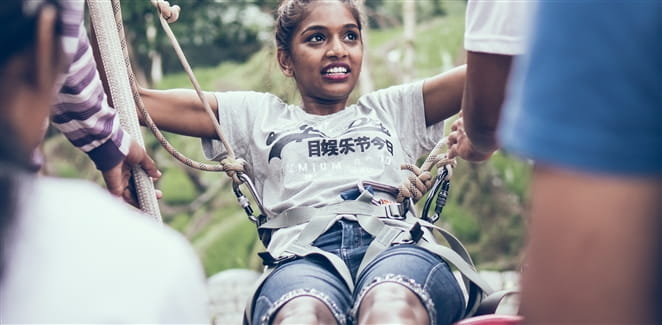 Woman strapped into a zipline harness